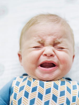 Crying baby suffering from colic